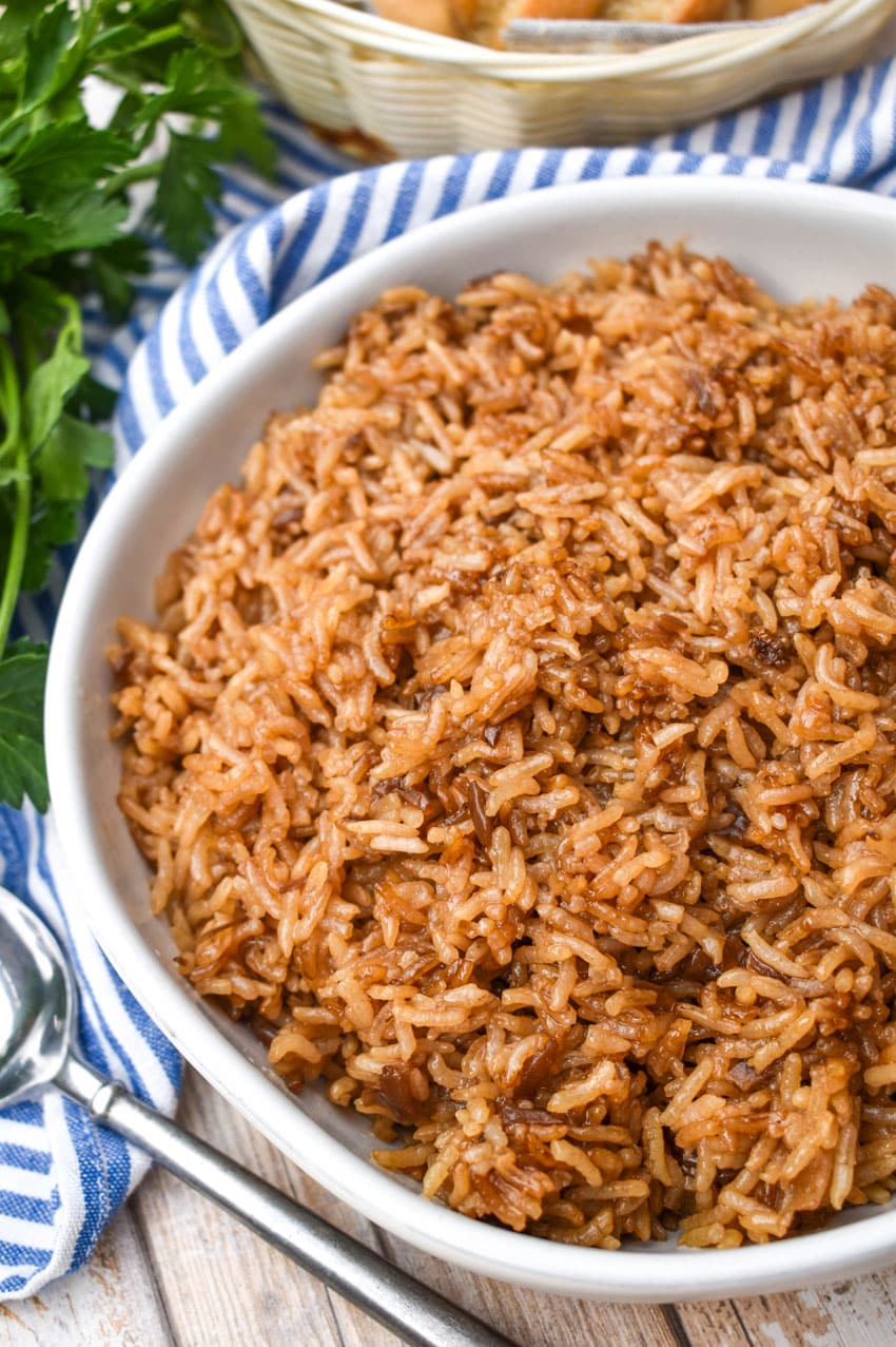 stick of butter rice in a large white serving bowl