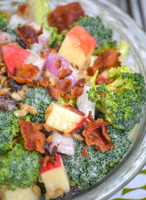 SWEET APPLE BROCCOLI AND BACON SALAD IN A GLASS BOWL