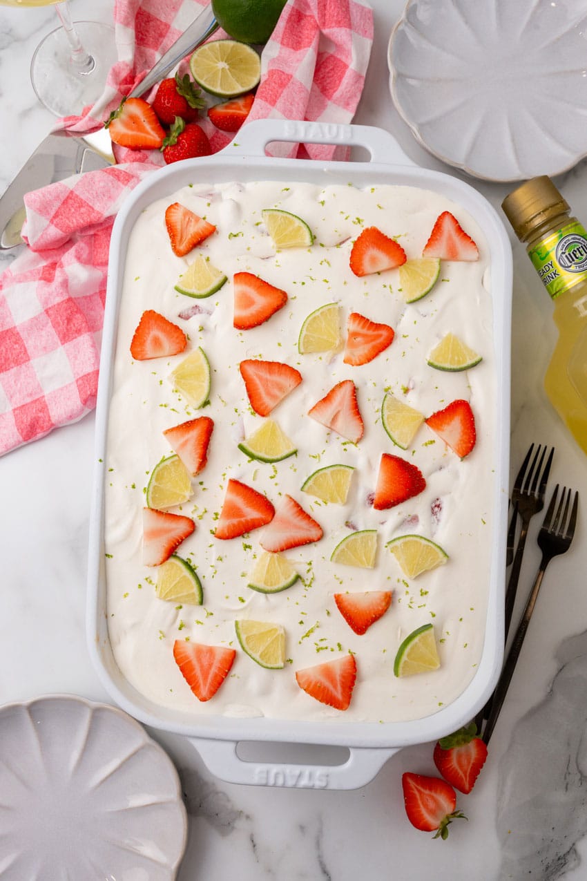 an overhead image showing a strawberry margarita poke cake