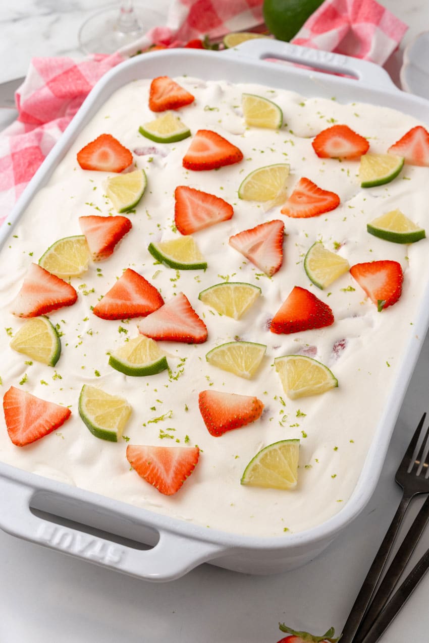 an overhead image showing a strawberry margarita poke cake