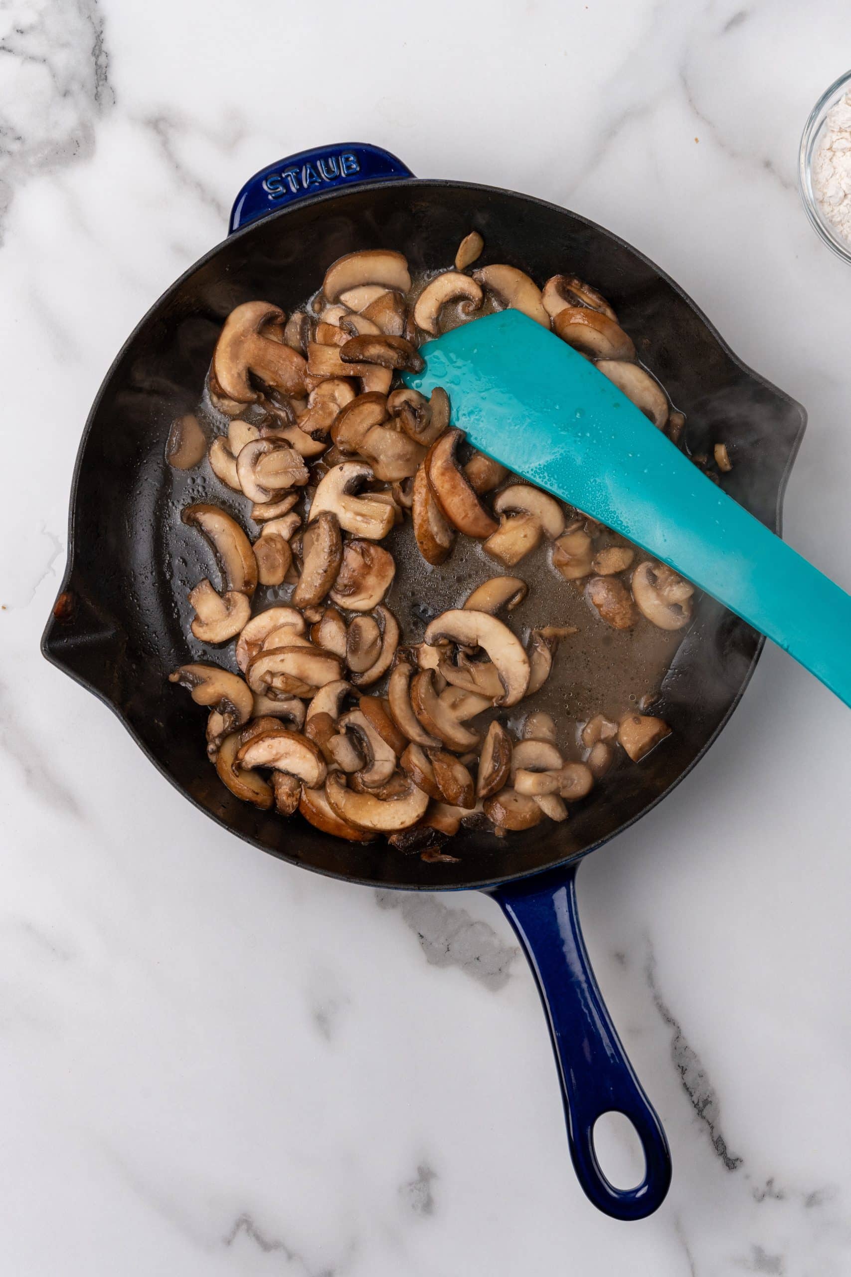 sauteed mushrooms in a black skillet