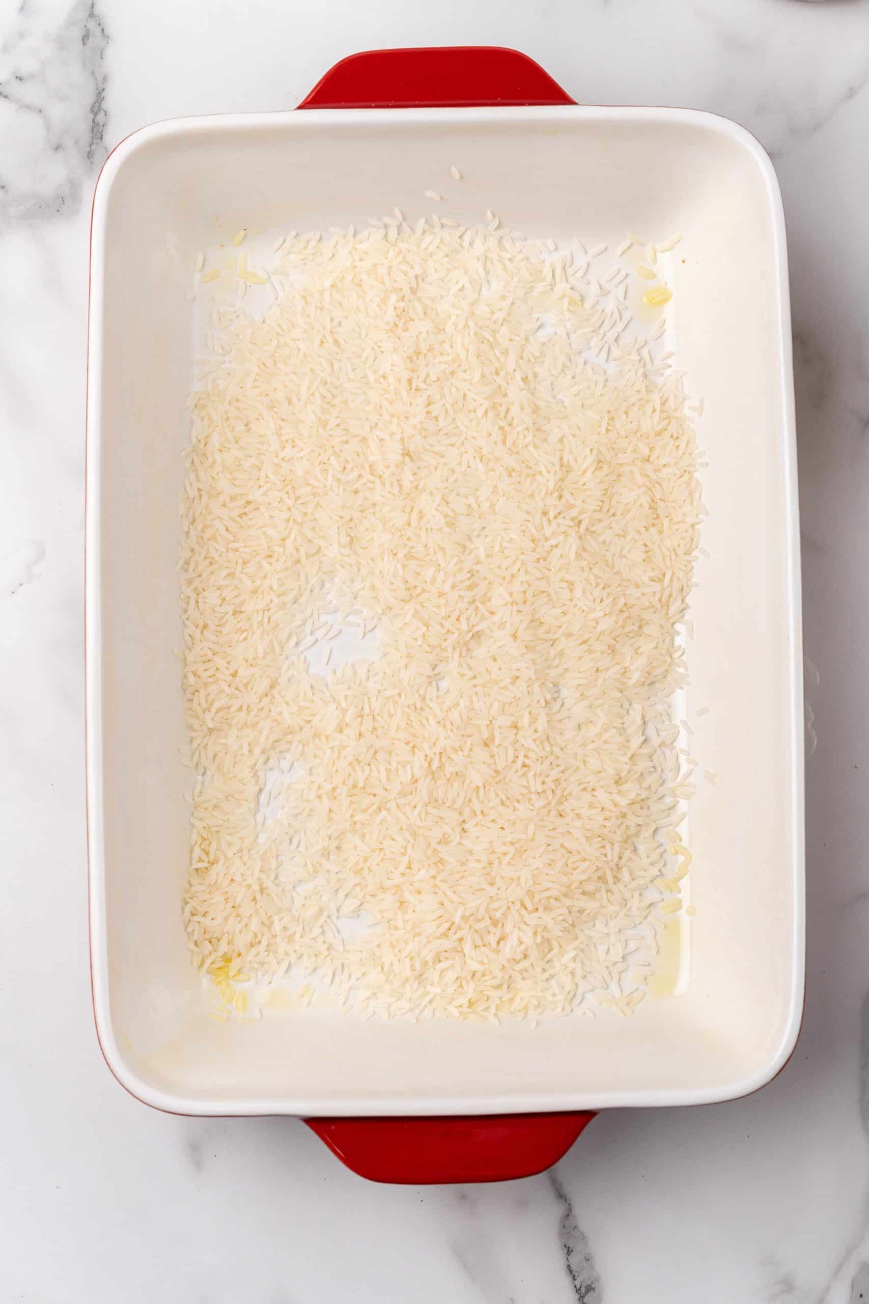 rice grains spread in a baking dish