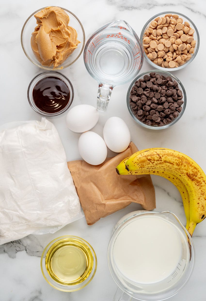 an overhead image showing the measured ingredients needed to make a peanut butter banana cake in a slow cooker