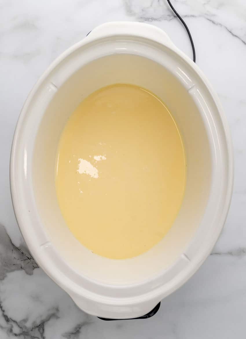 vanilla pudding in the bottom of a white crock