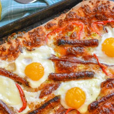 A BAKED BREAKFAST PIZZA ON A METAL SHEET PAN