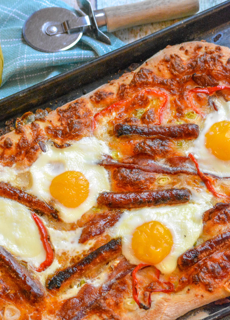 A BAKED BREAKFAST PIZZA ON A METAL SHEET PAN