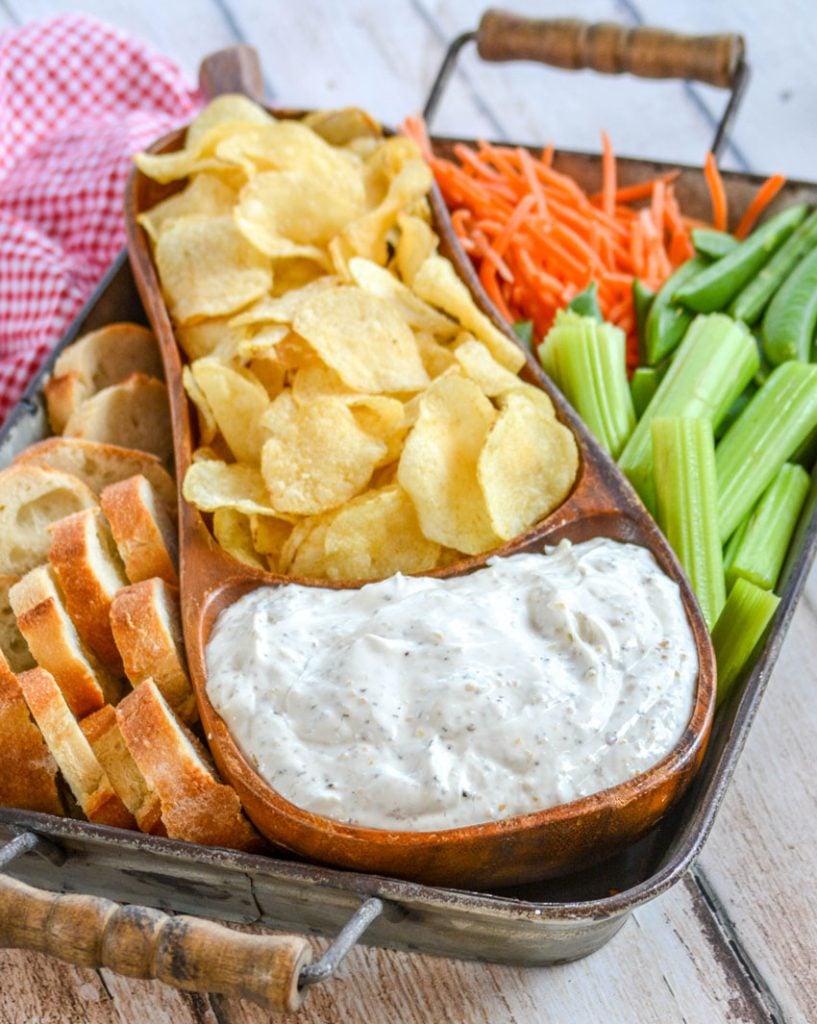 Montreal Steak Seasoning Dip served in a teak bowl with chips and veggies for dipping