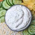 montreal steak seasoning dip in a small gray bowl surrounded by chips and crackers