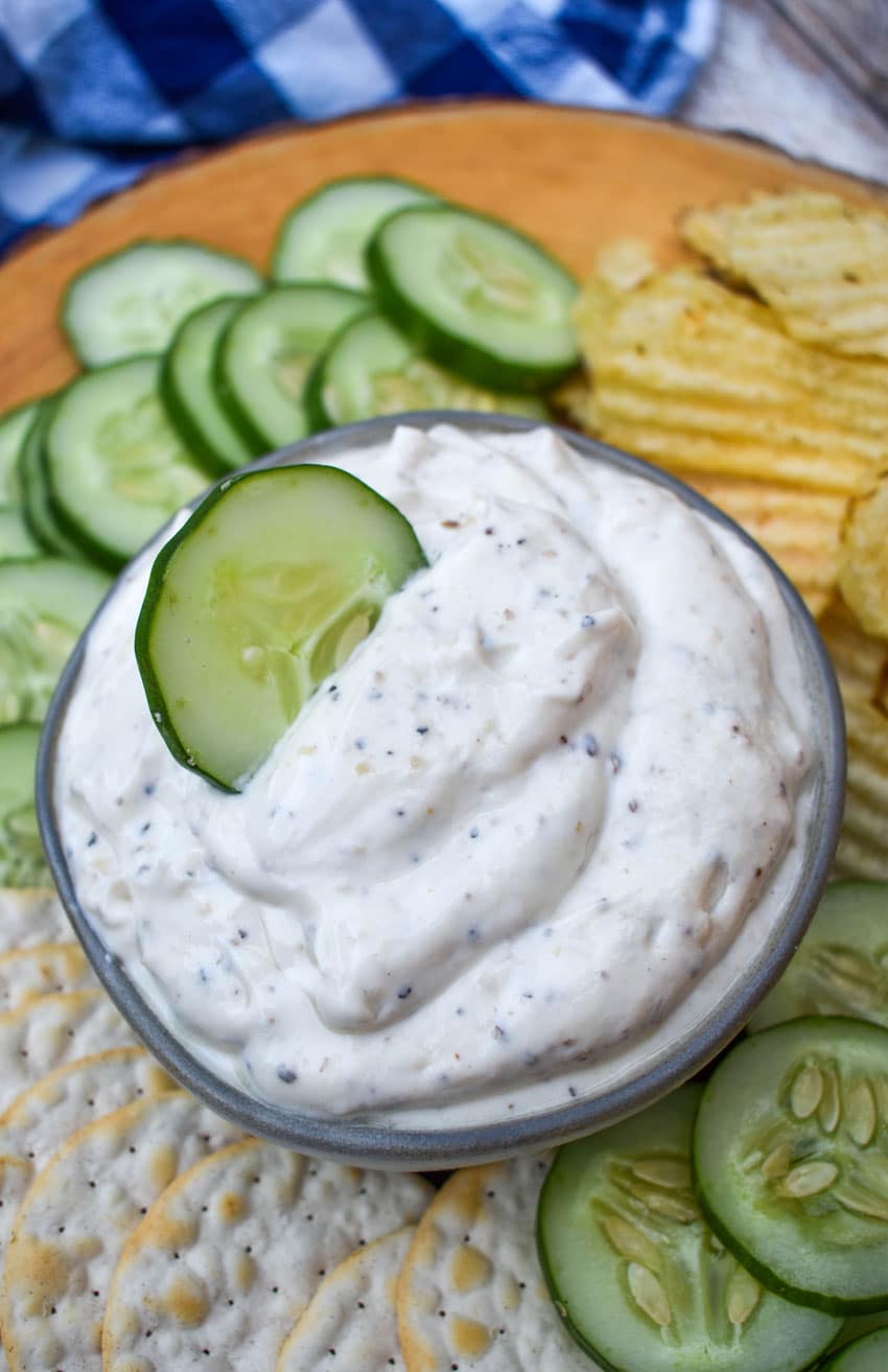 a cucumber slice stuck in a bowl of montreal steak seasoning dip