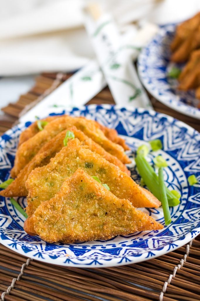 Shrimp Toast Recipe layered on a blue and white oriental style plate on a bamboo cutting board