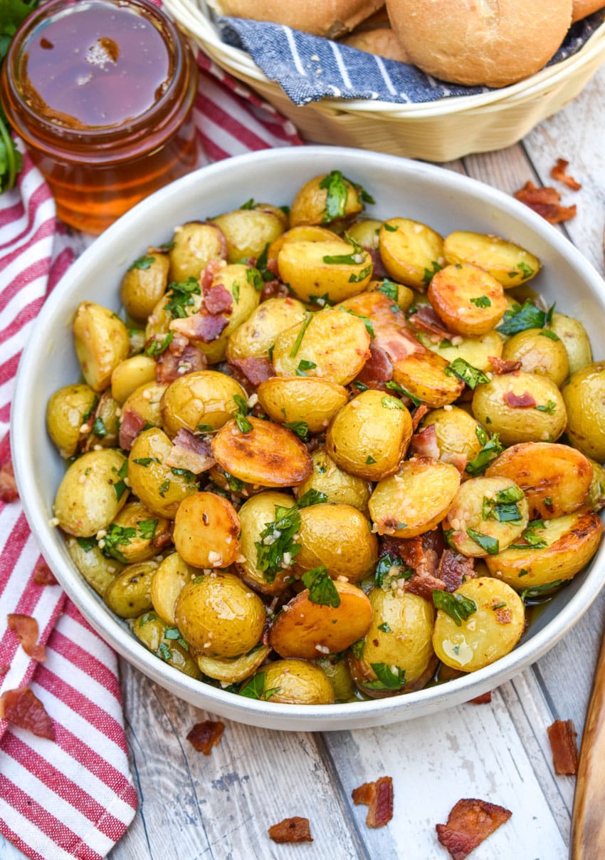 honey mustard potato salad with bacon in a white bowl