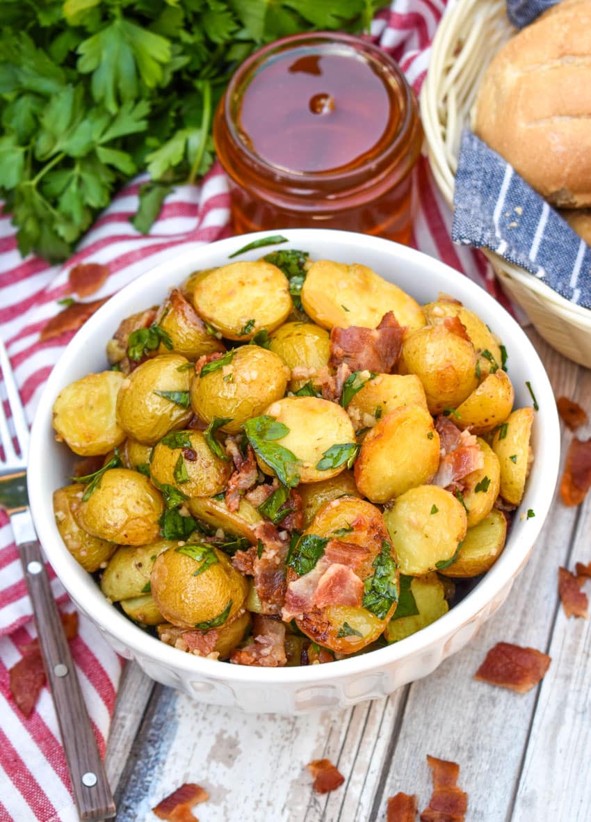 honey mustard potato salad with bacon in a white bowl
