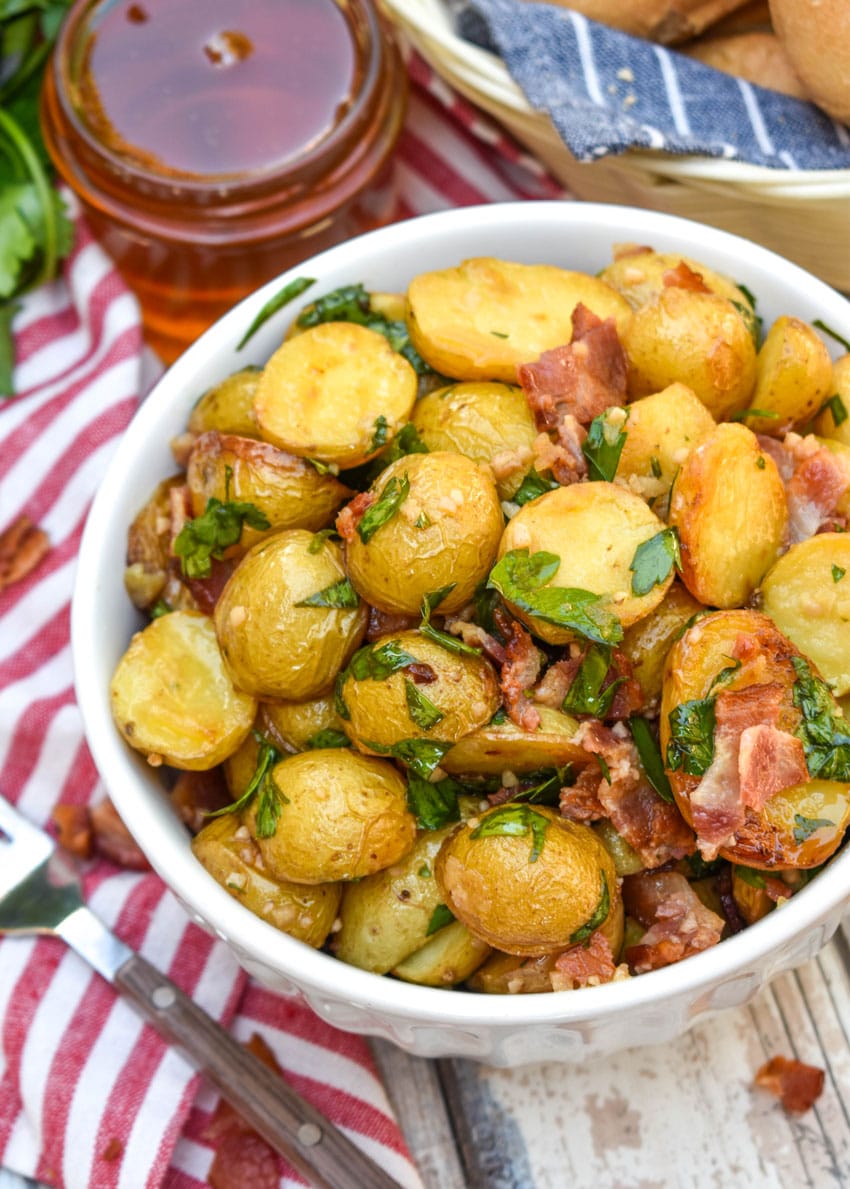 honey mustard potato salad with bacon in a white bowl