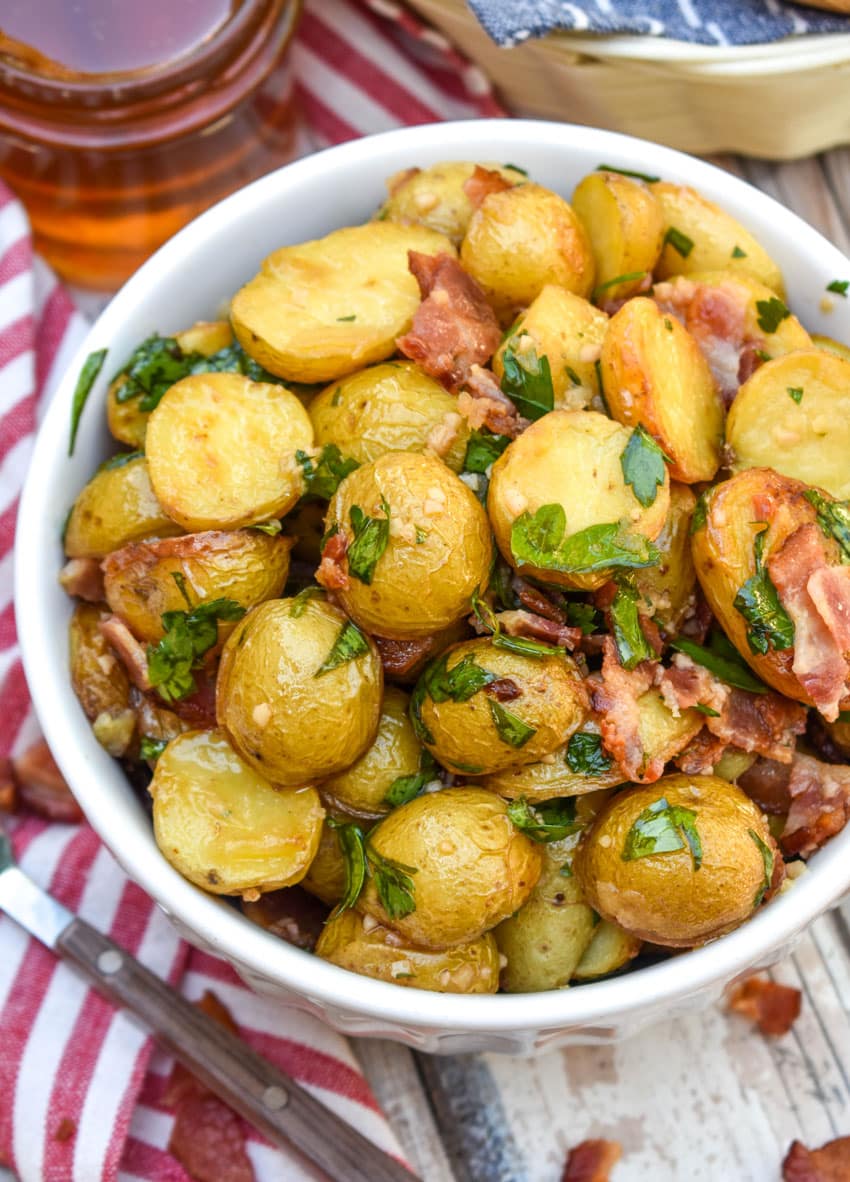 honey mustard potato salad with bacon in a white bowl