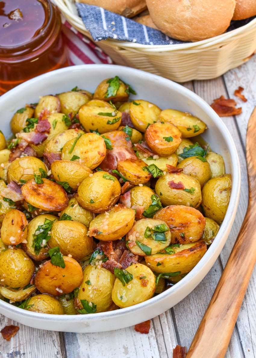 honey mustard potato salad with bacon in a white bowl