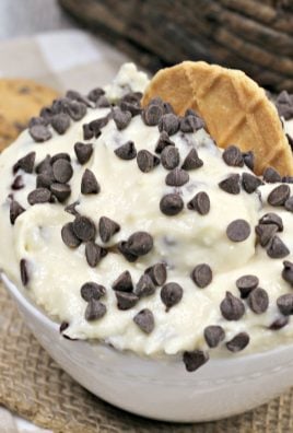 italian cannoli dip in a small white bowl topped with chocolate chips and a waffle cookie