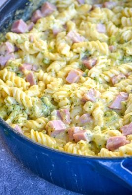 cheesy ham and broccoli pasta in a blue cast iron skillet