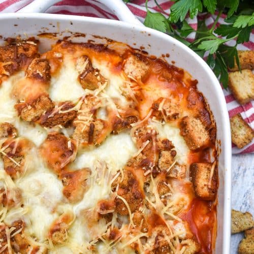 chicken parmesan casserole in a white baking dish