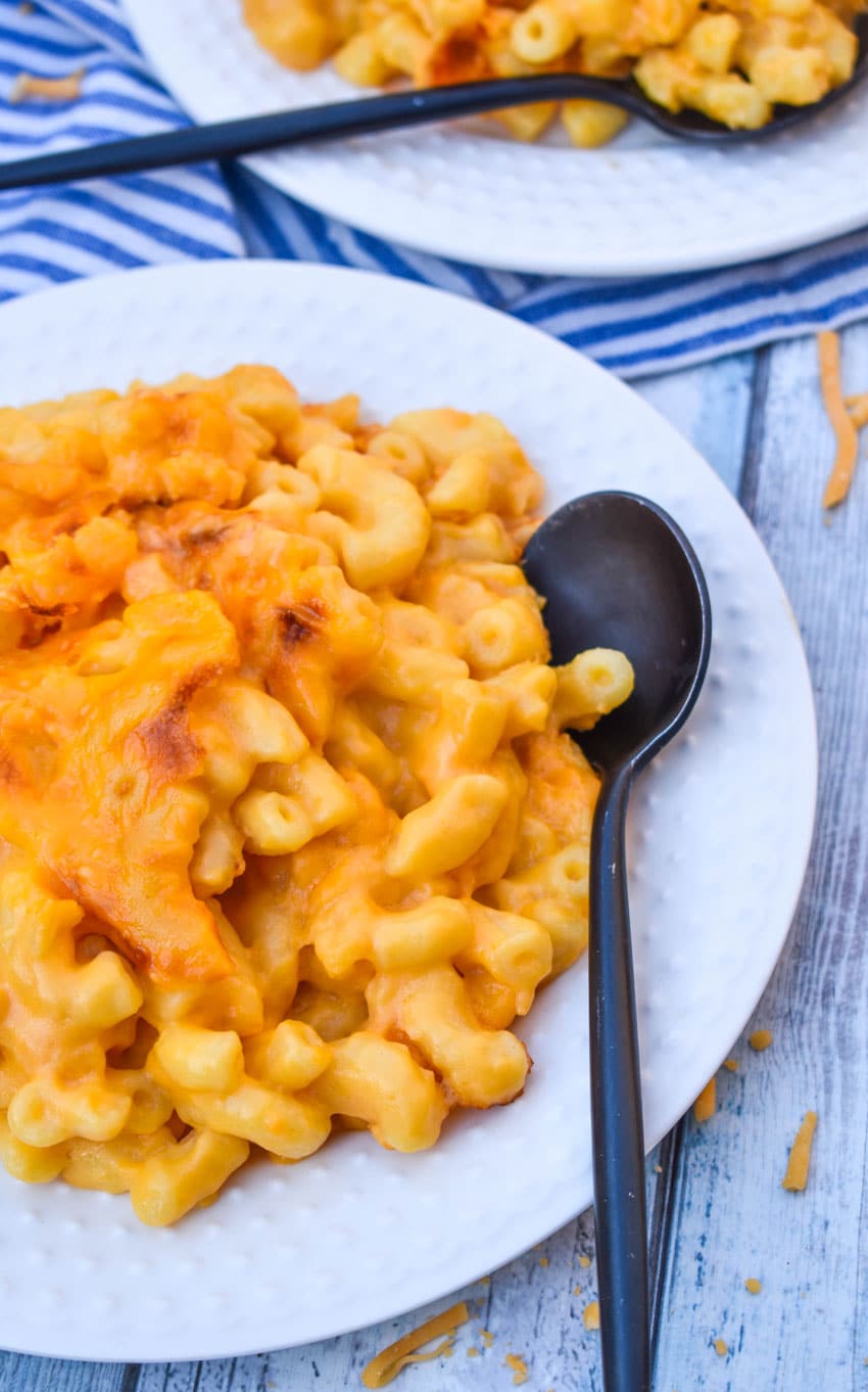 homemade stouffer's mac and cheese on a white dinner plate with a black spoon resting on the side