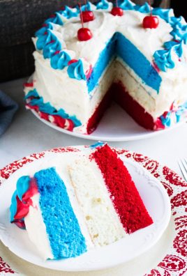 a slice of red white and blue layer cake on a small white plate