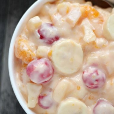 ORANGE CREAM FRUIT SALAD IN A WHITE BOWL