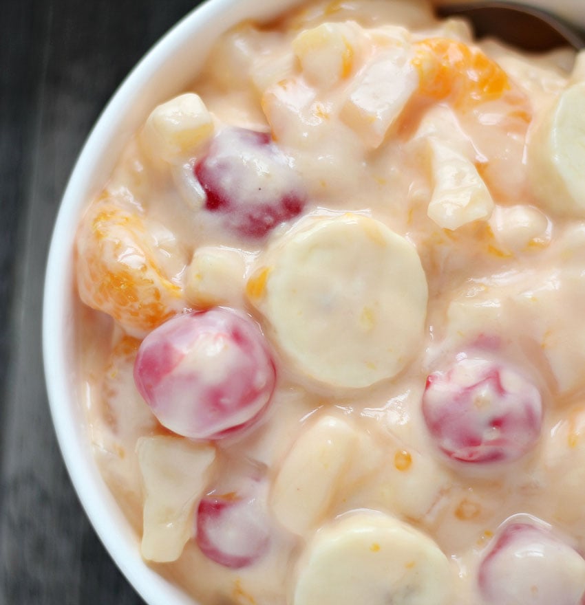 ORANGE CREAM FRUIT SALAD IN A WHITE BOWL