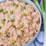 buffalo ranch chicken salad in a large gray serving bowl surrounded by green onions