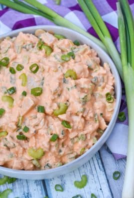 buffalo ranch chicken salad in a large gray serving bowl surrounded by green onions