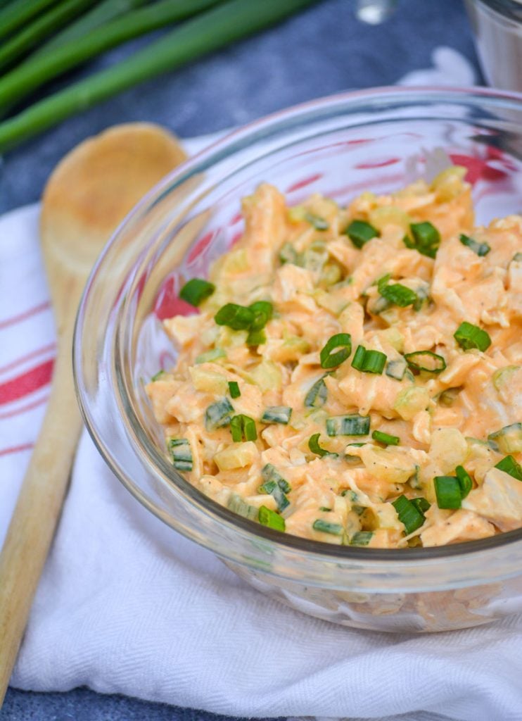 a glass bowl full of buffalo ranch chicken salad