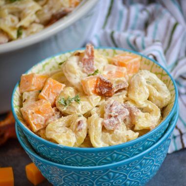 cheddar bacon ranch tortellini salad in a light blue bowl