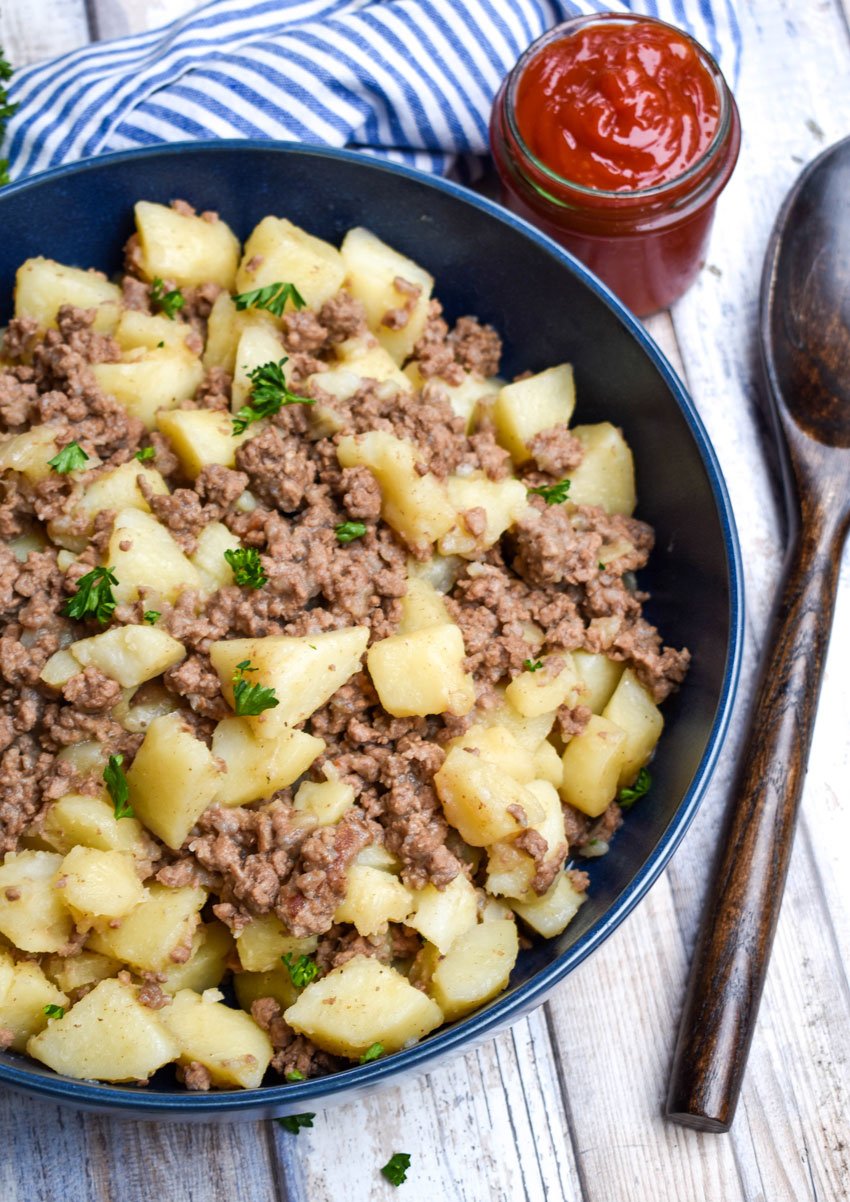 potato hash recipe with ground beef in a large blue serving bowl