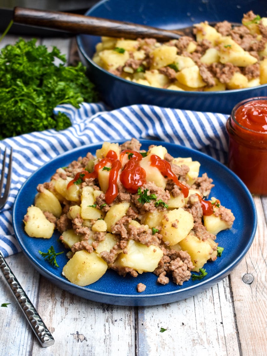 instant pot ground beef and potato hash on a blue plate