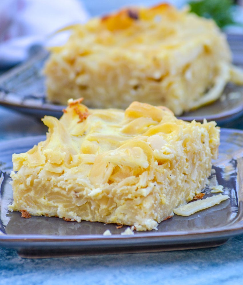 creamy Italian macaroni pie shows layers of noodles with cheesy texture on glossy brown plates