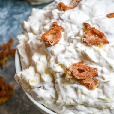 PINEAPPLE FLUFF PRETZEL SALAD IN A WHITE BOWL