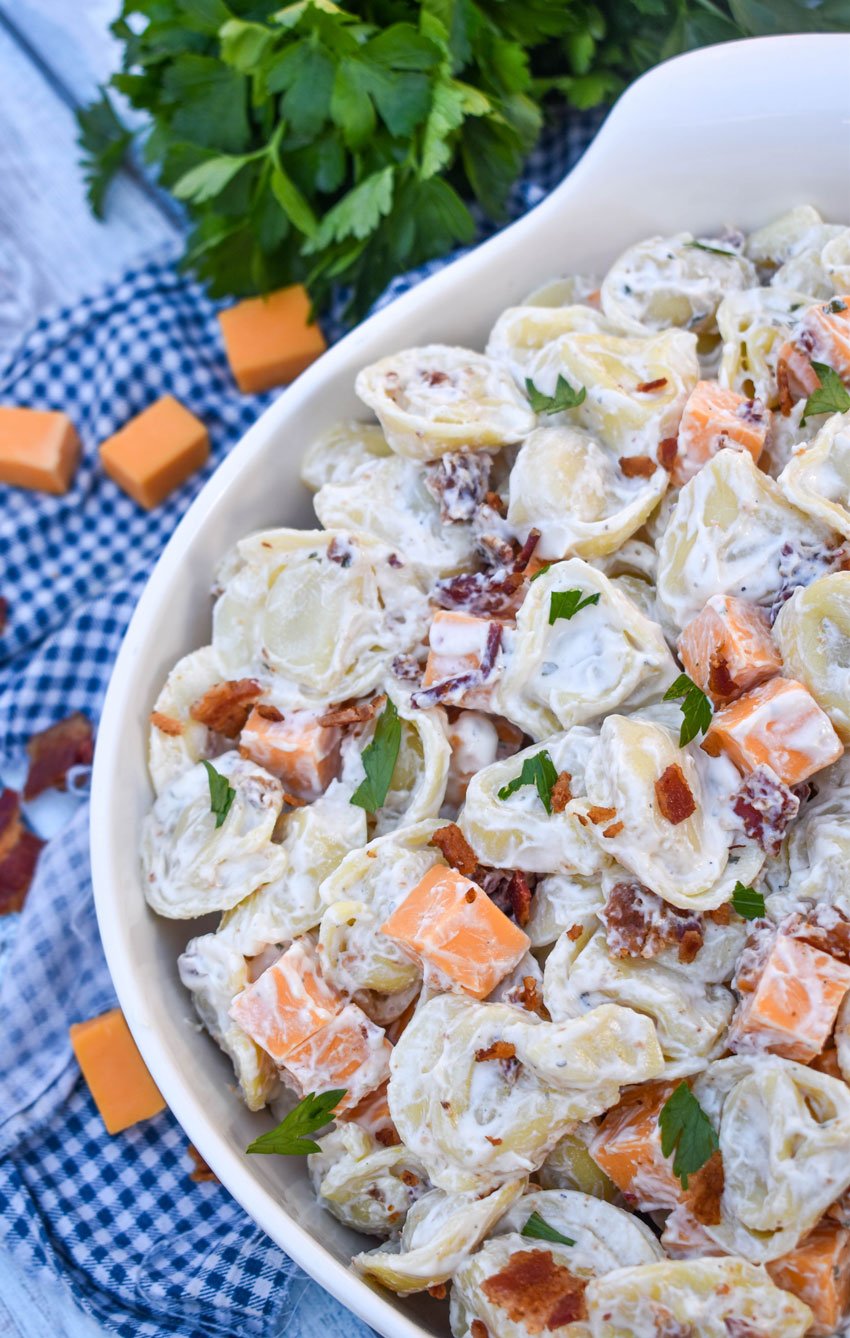 creamy tortellini salad with ranch dressing in a large white serving bowl