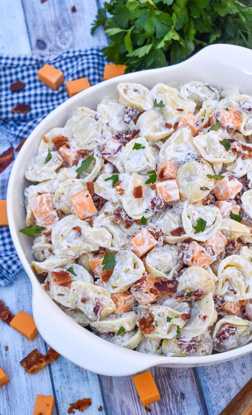 creamy tortellini salad with ranch dressing in a large white serving bowl