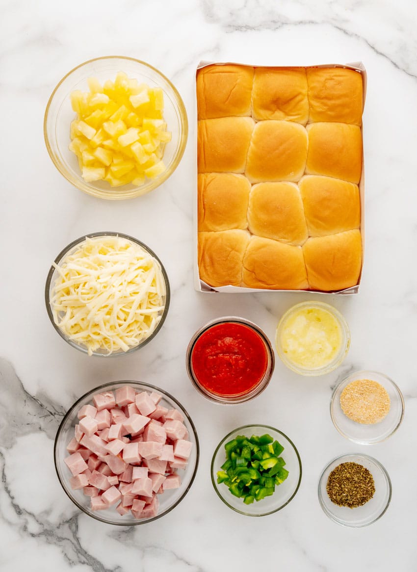 an overhead image showing the measured ingredients needed to make a batch of baked hawaiian pizza sliders