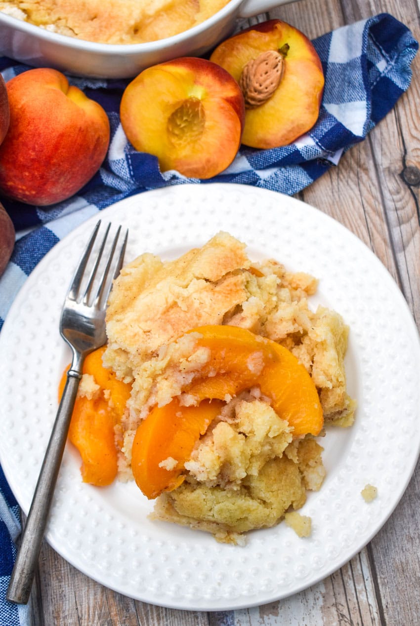 peach cobbler dump cake on a small white dessert plate