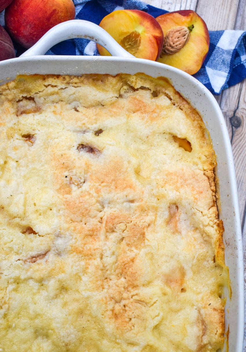 peach cobbler dump cake in a white baking dish