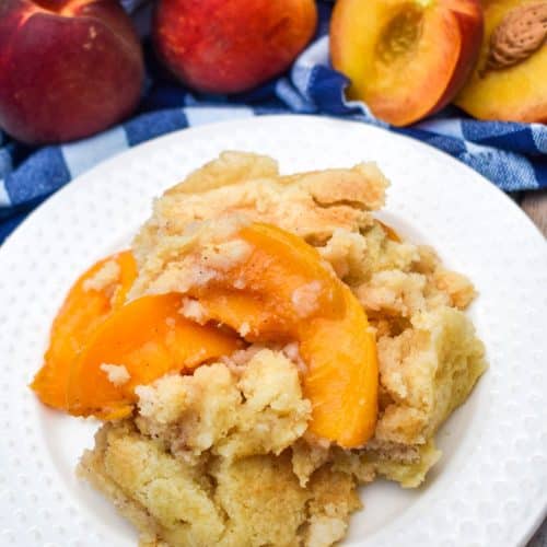 peach cobbler dump cake on a small white dessert plate