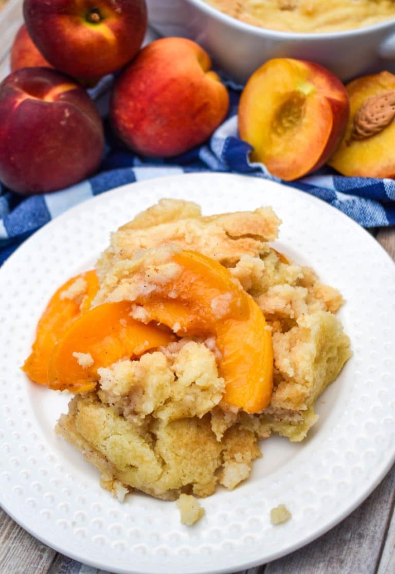 peach cobbler dump cake on a small white dessert plate