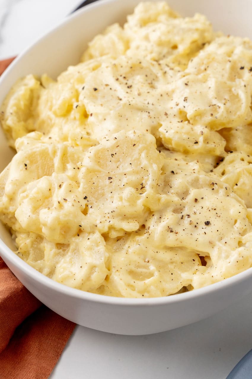 grandma's simple southern potato salad in a white serving bowl