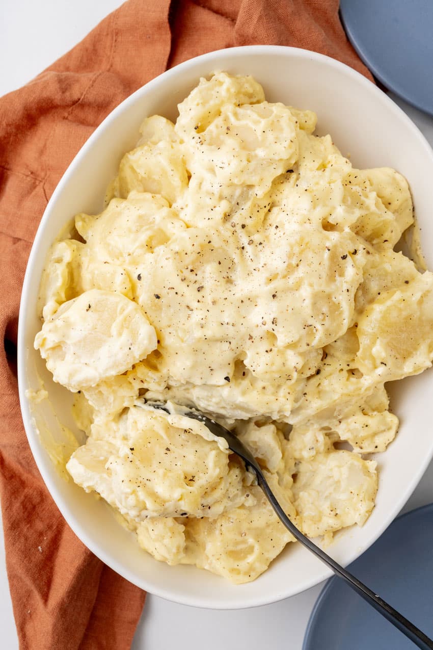 grandma's simple southern potato salad in a white serving bowl