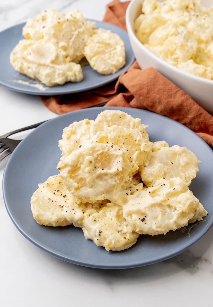 creamy southern potato salad on two small blue plate