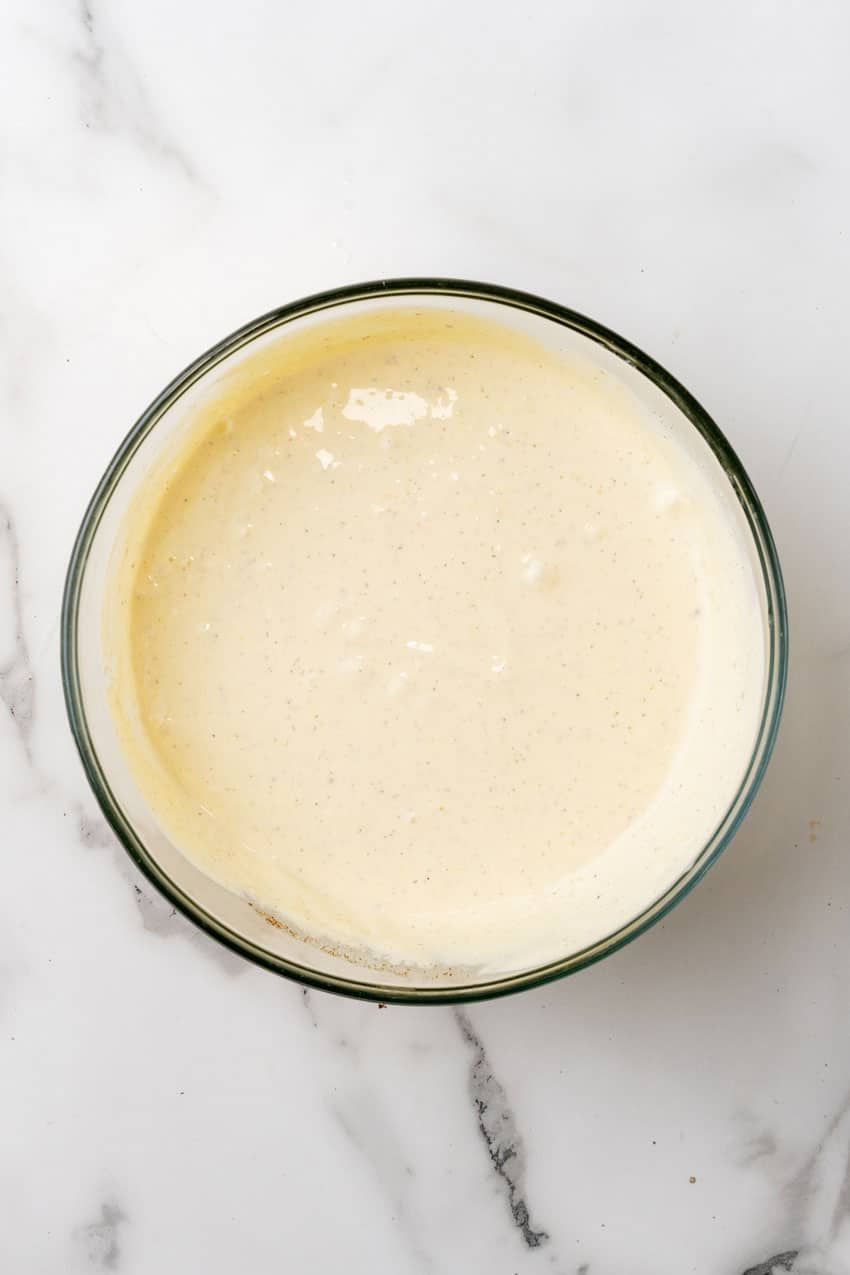 a creamy homemade potato salad dressing in a glass mixing bowl
