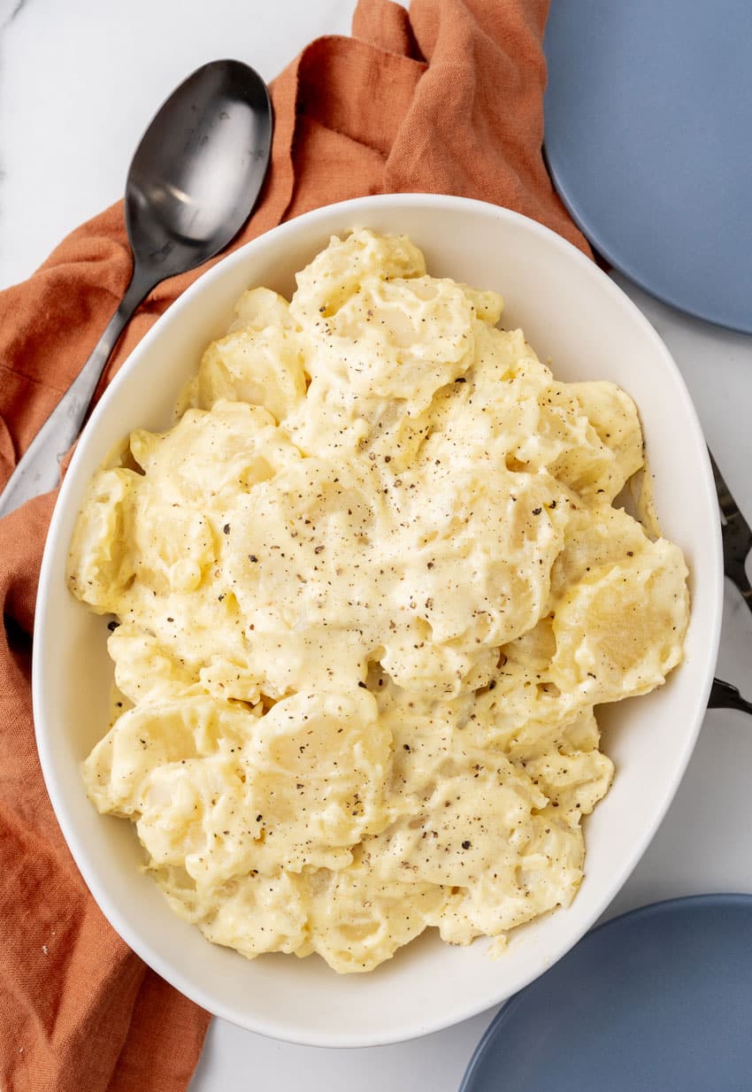 grandma's simple southern potato salad in a white serving bowl