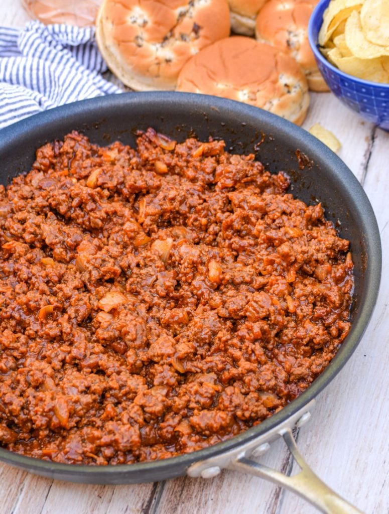 Grandma's from scratch sloppy joe ground beef mixture shown in a black non stick metal skillet