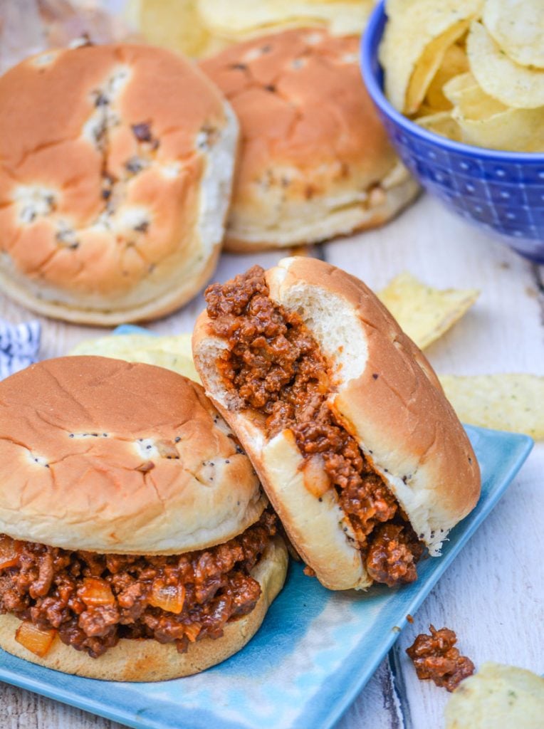 Grandma's sloppy joe's from scratch served on light blue plates with potato chips