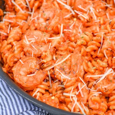 creamy shrimp tomato pasta in a black skillet