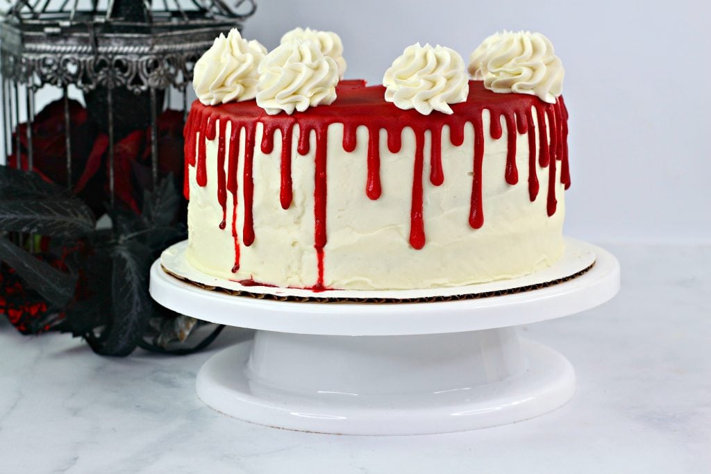 designer chef decorating white red bloody horror crime cake for halloween  party Stock Photo by columbophotog